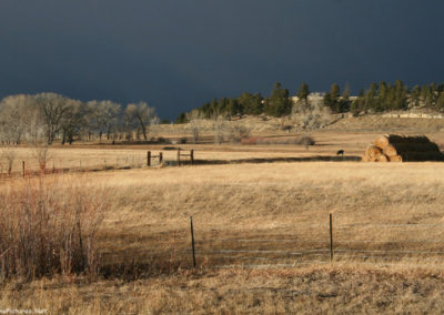 January picture of a sun lit hay stack on Highway 12 west of Ryegate, Montana. Image is from the Ryegate Montana Picture Tour.