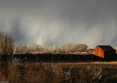 January picture of a sun lit red barn on Highway 12 west of Ryegate, Montana. Image is from the Ryegate Montana Picture Tour.